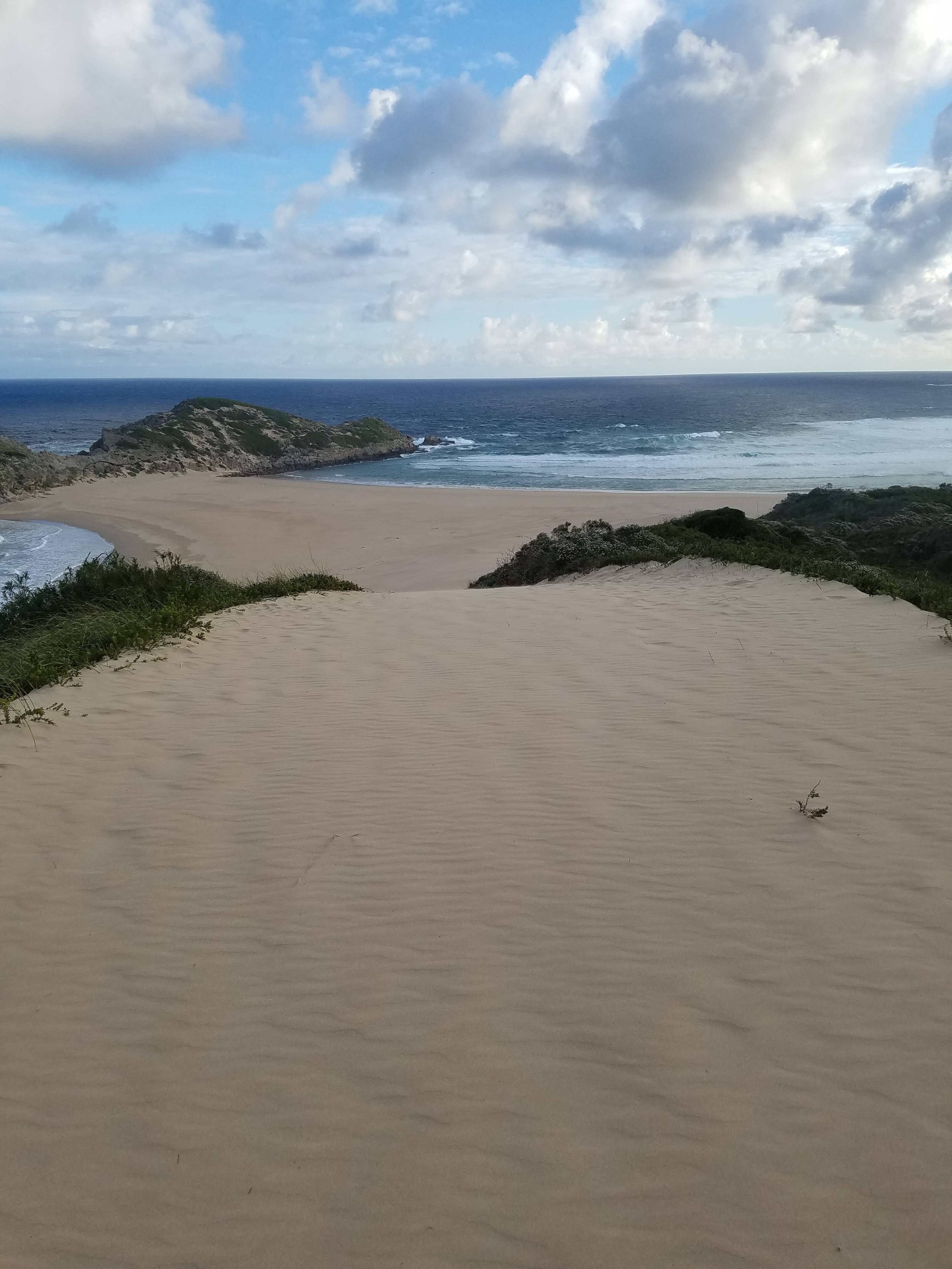 A beautiful sandy beach sticks out like a finger in Plettenberg Bay
