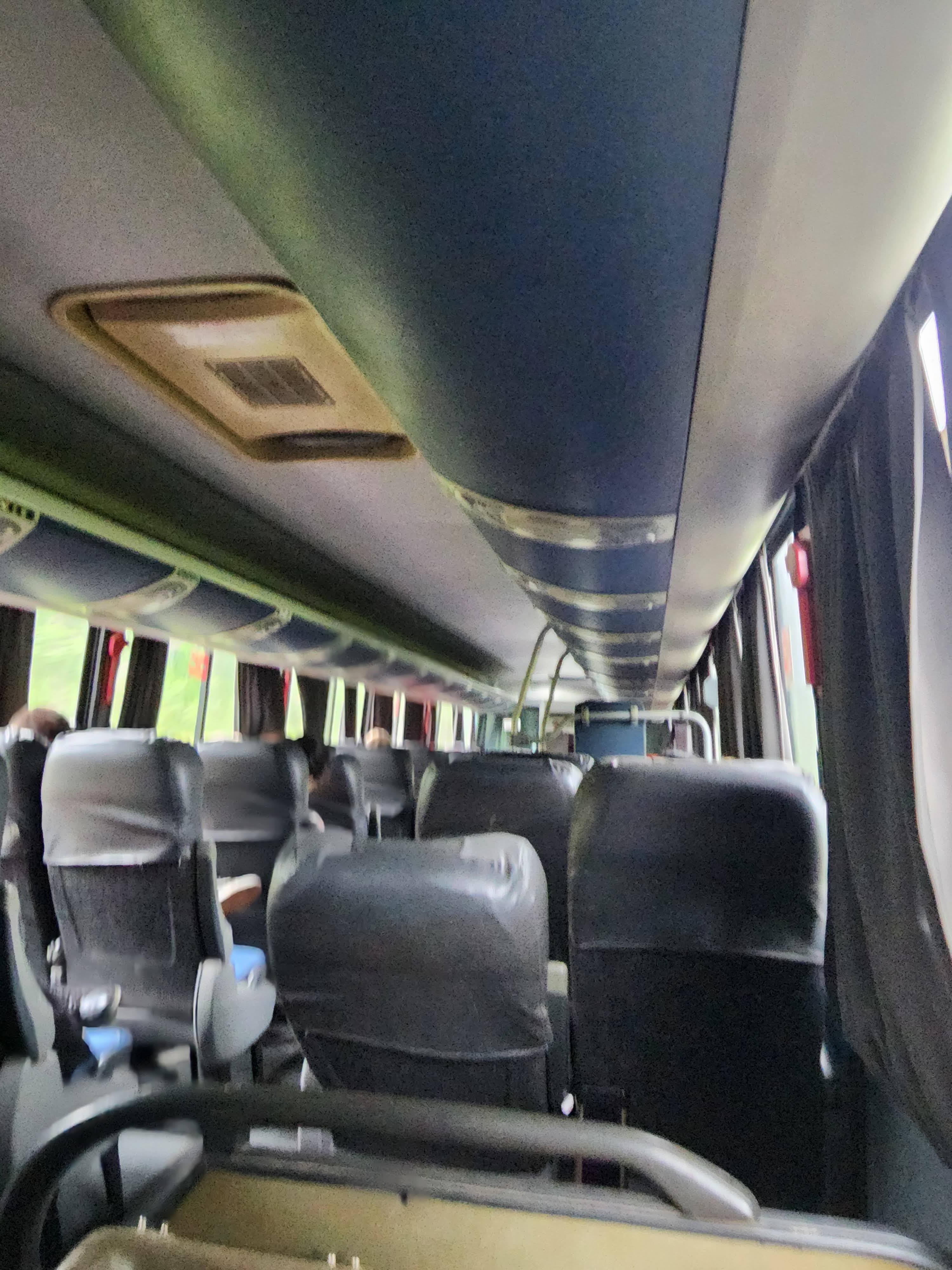 A blurry picture of the interior of a coach bus