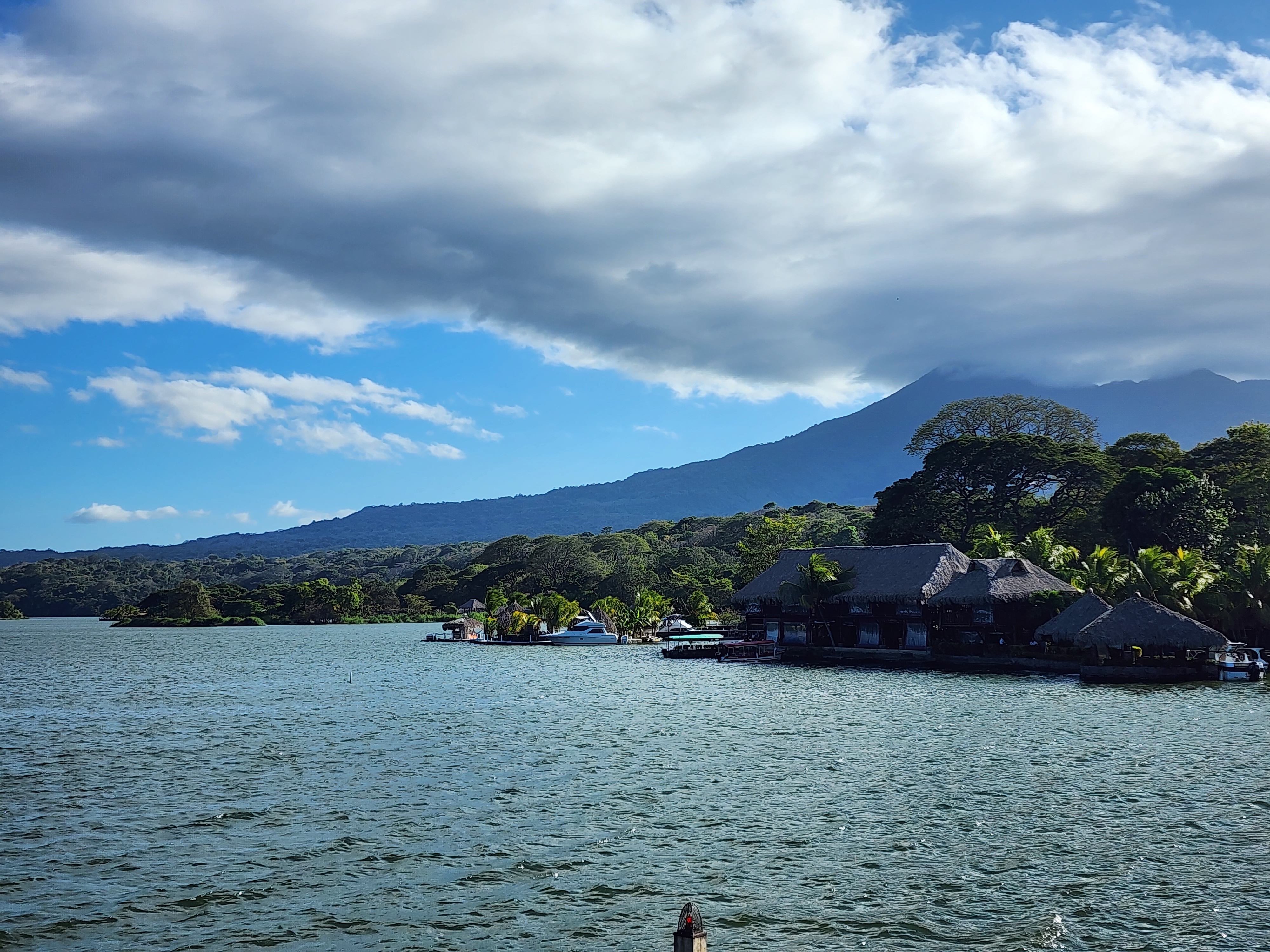 The bottom of a large volcano reaches the shores of the lake