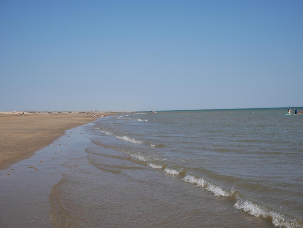 The tide comes in at a long stretch of English Beach