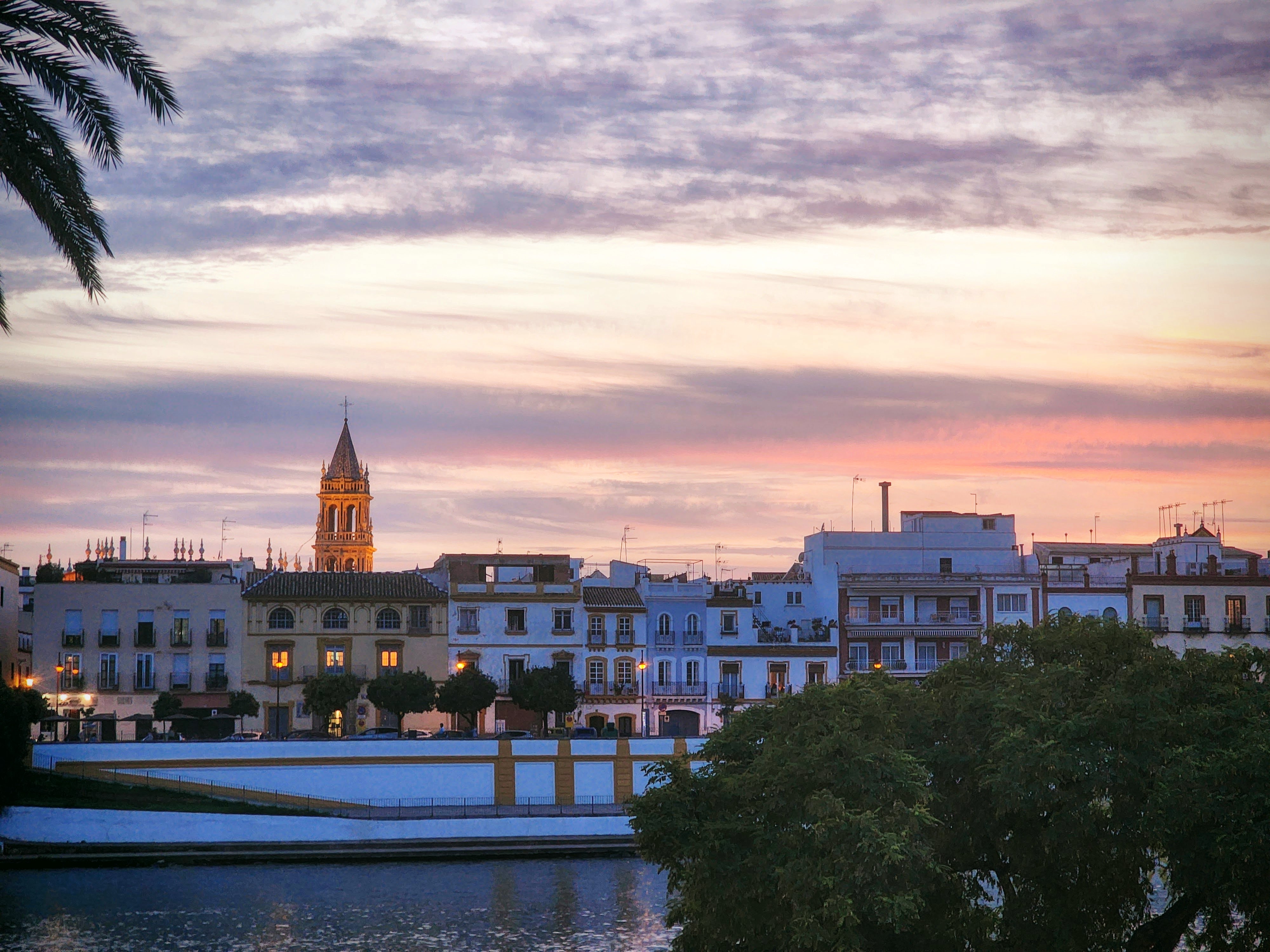 Seville is lit up in pinks, oranges, and reds as the sun goes down