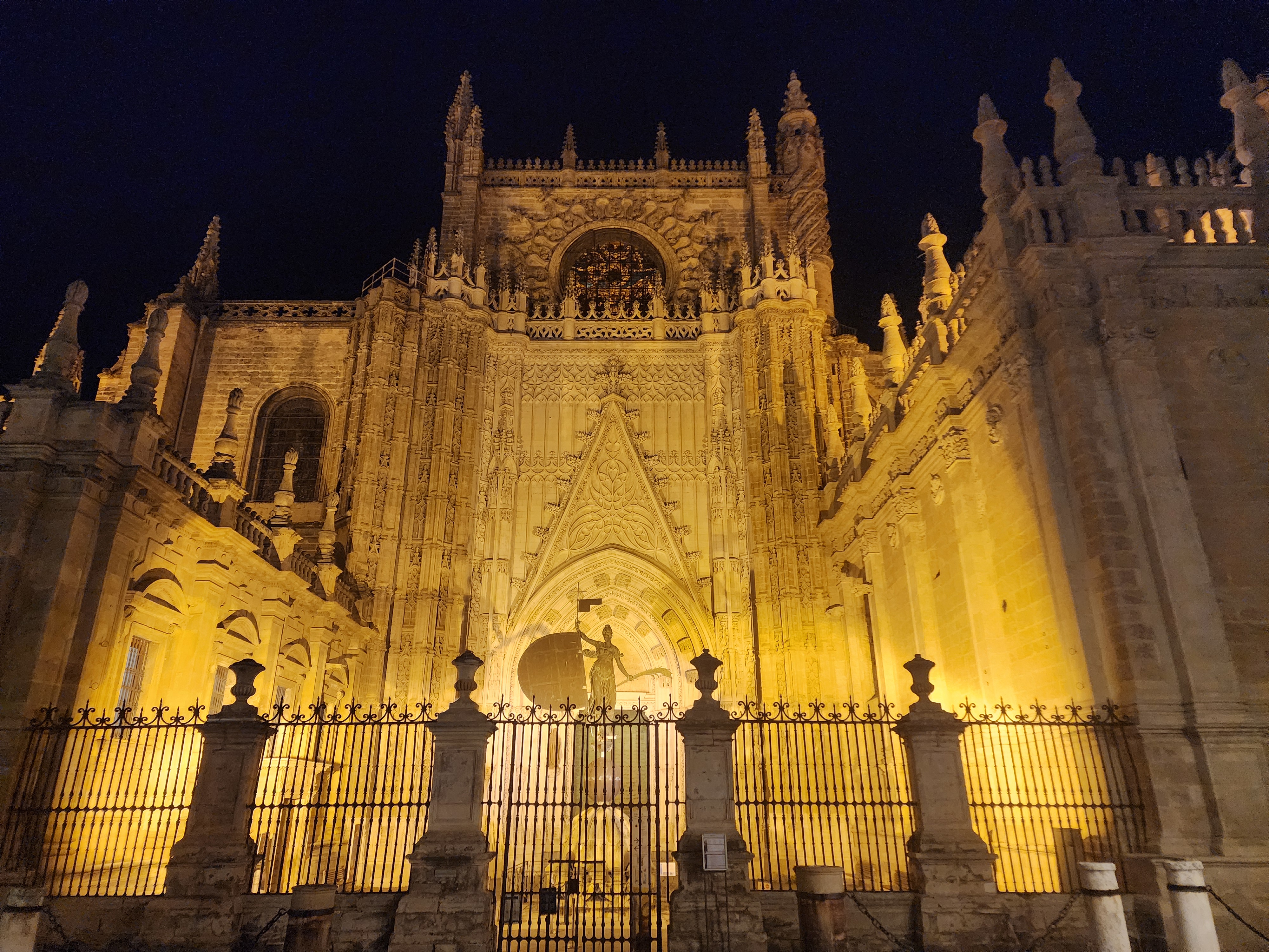 A massive Gothic cathedral lit up at night