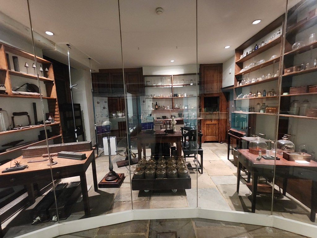 A display of a laboratory behind glass in a museum