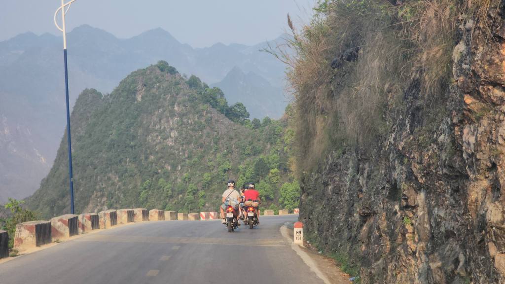 Two motorbikes on a cliff-side road in the Ha Giang region in Northern Vietnam