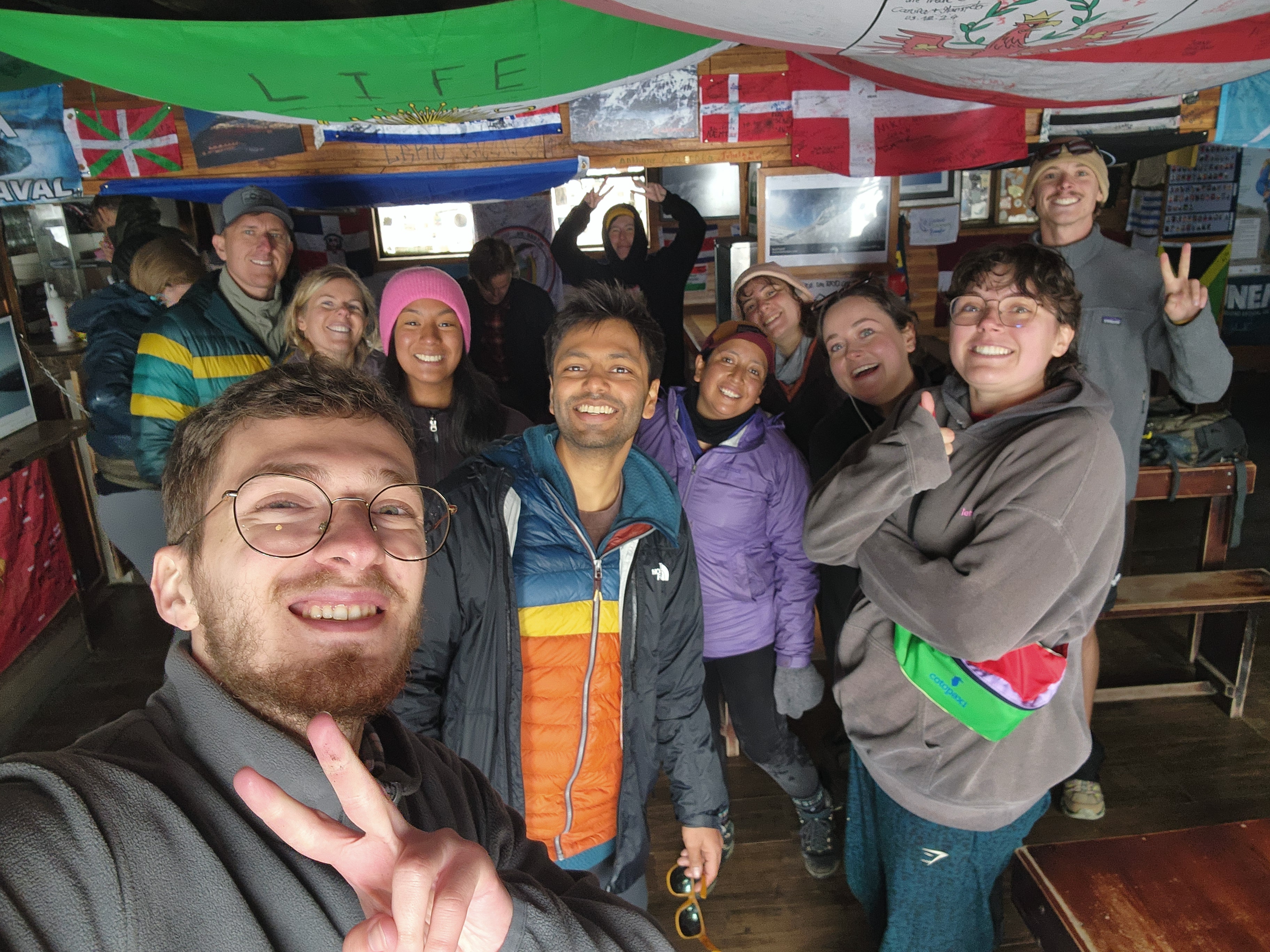 A group of excited hikers smiling at the camera after a tough trek in the cold.